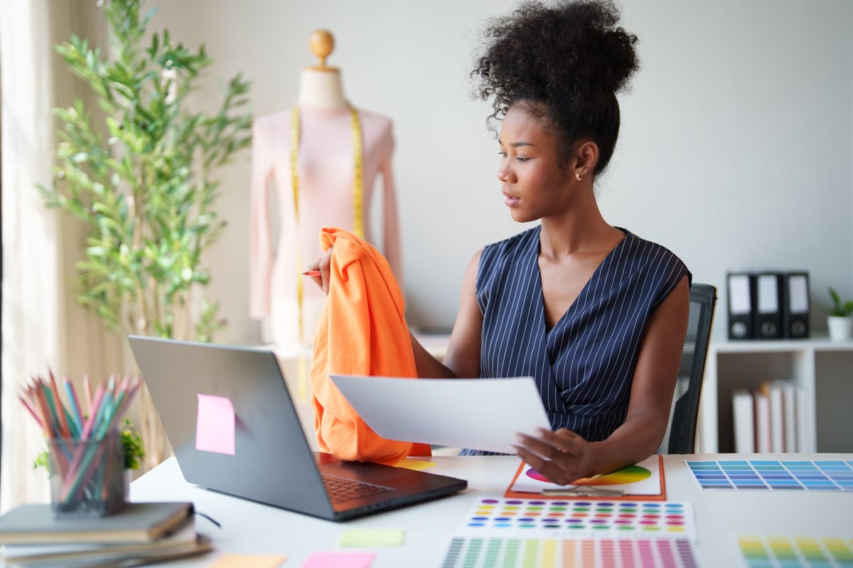 A designer developing a new collection, selecting fabric and colour palettes
