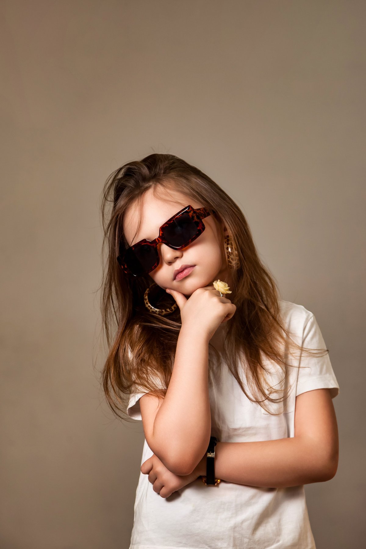 A young model striking a confident pose in fashionable sunglasses